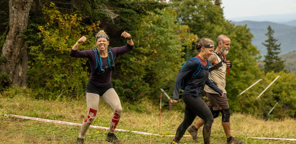 Spartan racer showing their guns as they continue towards the finish line