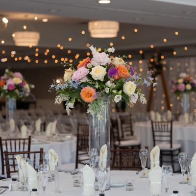 Elegant wedding setup with floral centerpieces and tables ready for guests.