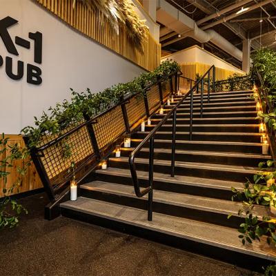 Stairs leading to K-1 Pub, adorned with greenery and candles along the steps.