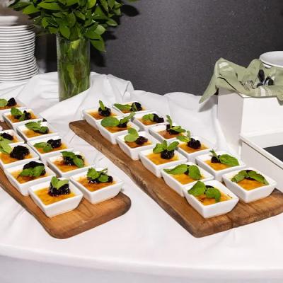 Desserts on display: tiramisu and crème brûlée in small dishes with mint garnish.