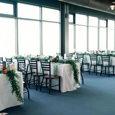 Elegant dining setup with decorated tables and large windows.
