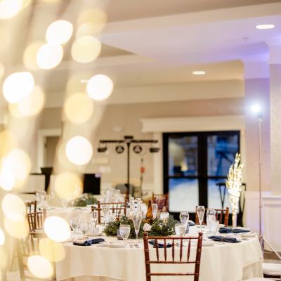 Elegantly set dining table adorned with glassware and a festive centerpiece.