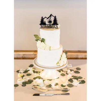 Wedding cake decorated with white flowers and a 