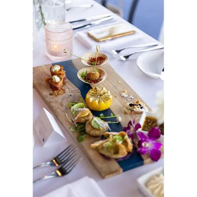 A beautifully arranged platter of gourmet appetizers on a wooden board.