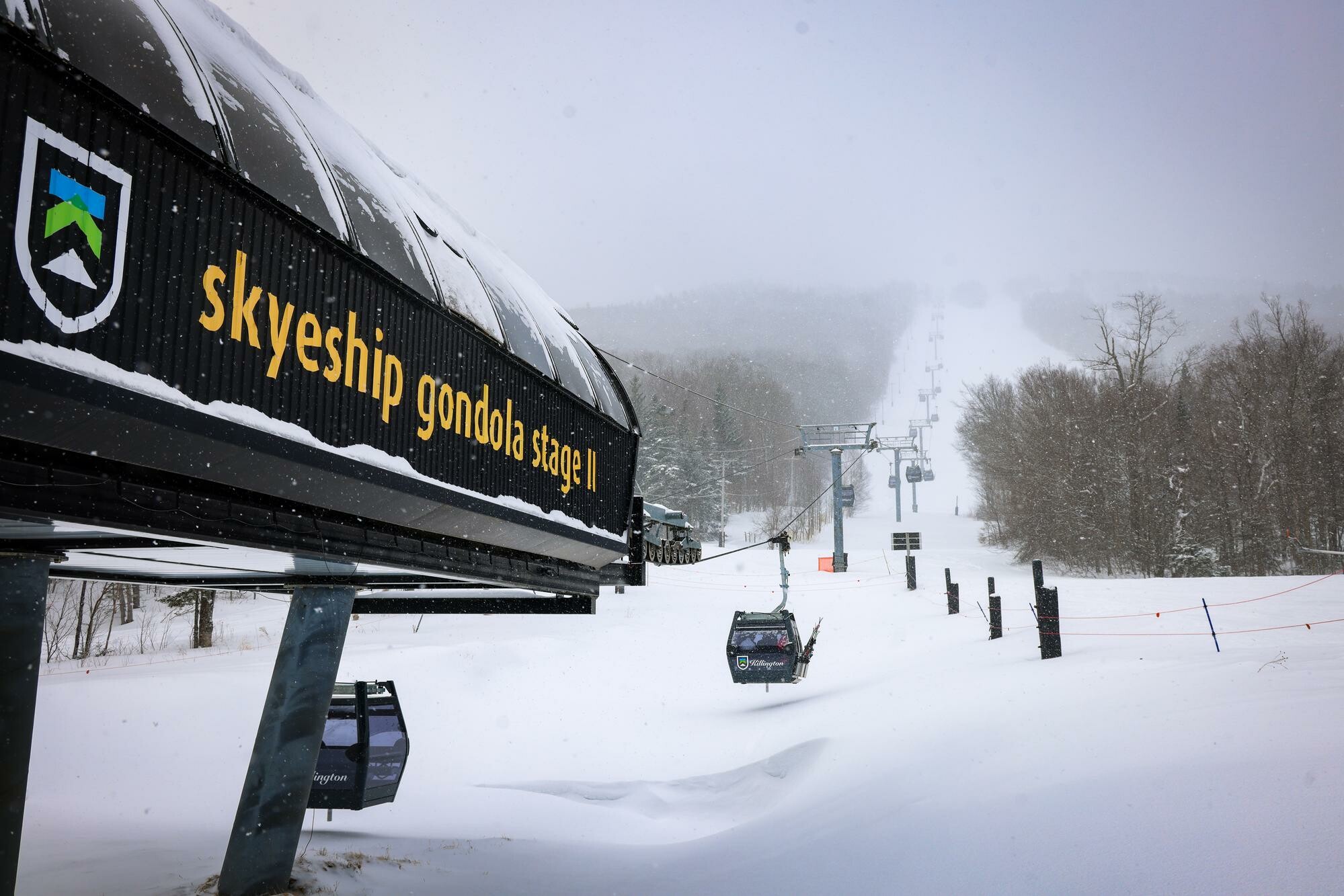 Snowy landscape featuring the Skyeship gondola and ski lift in a winter setting.