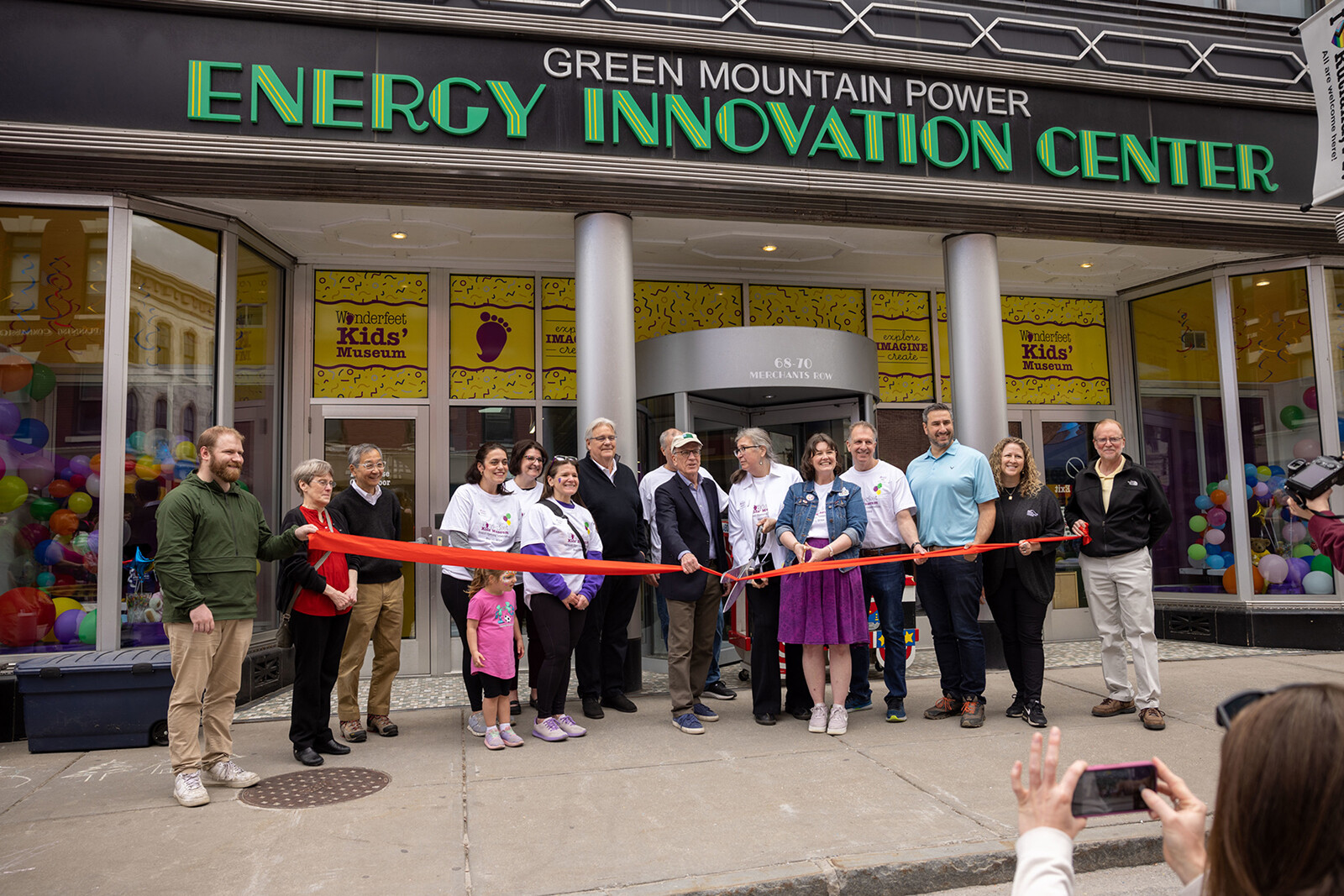 Group of people cutting a ribbon in Rutland, VT.