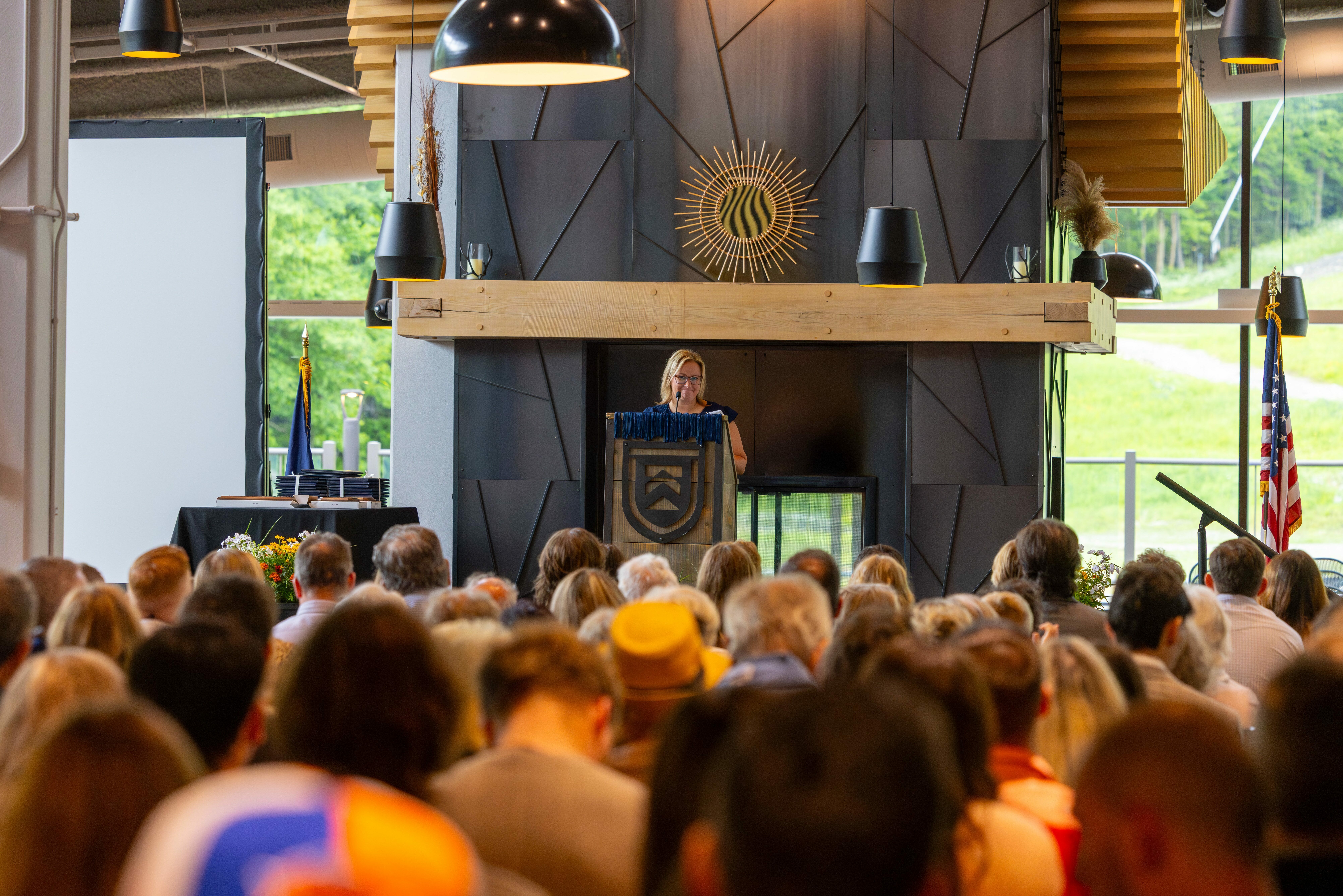 Program Coordinator speaks during 2026 RHM graduation ceremony