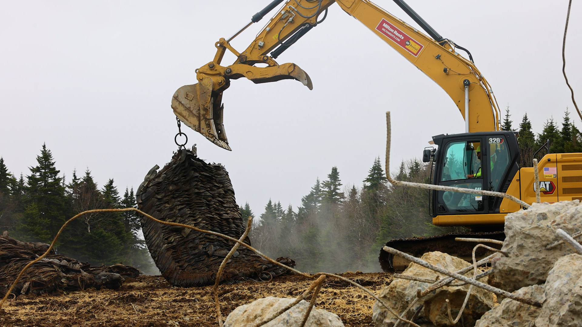 Construction vehicles move large blasting mats during Snowdon Quad construction at Killington