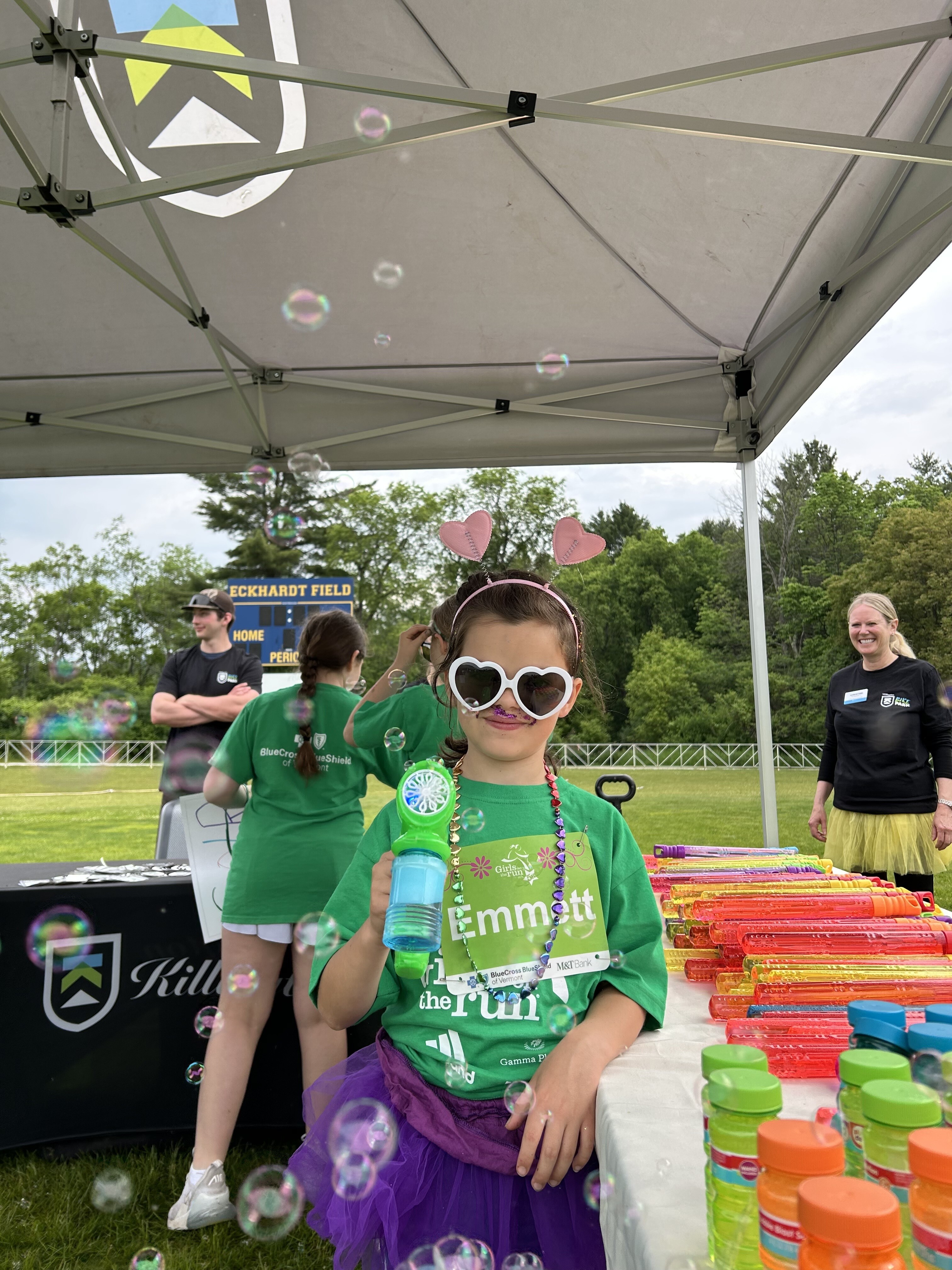 Child holding bubble wand at event setup