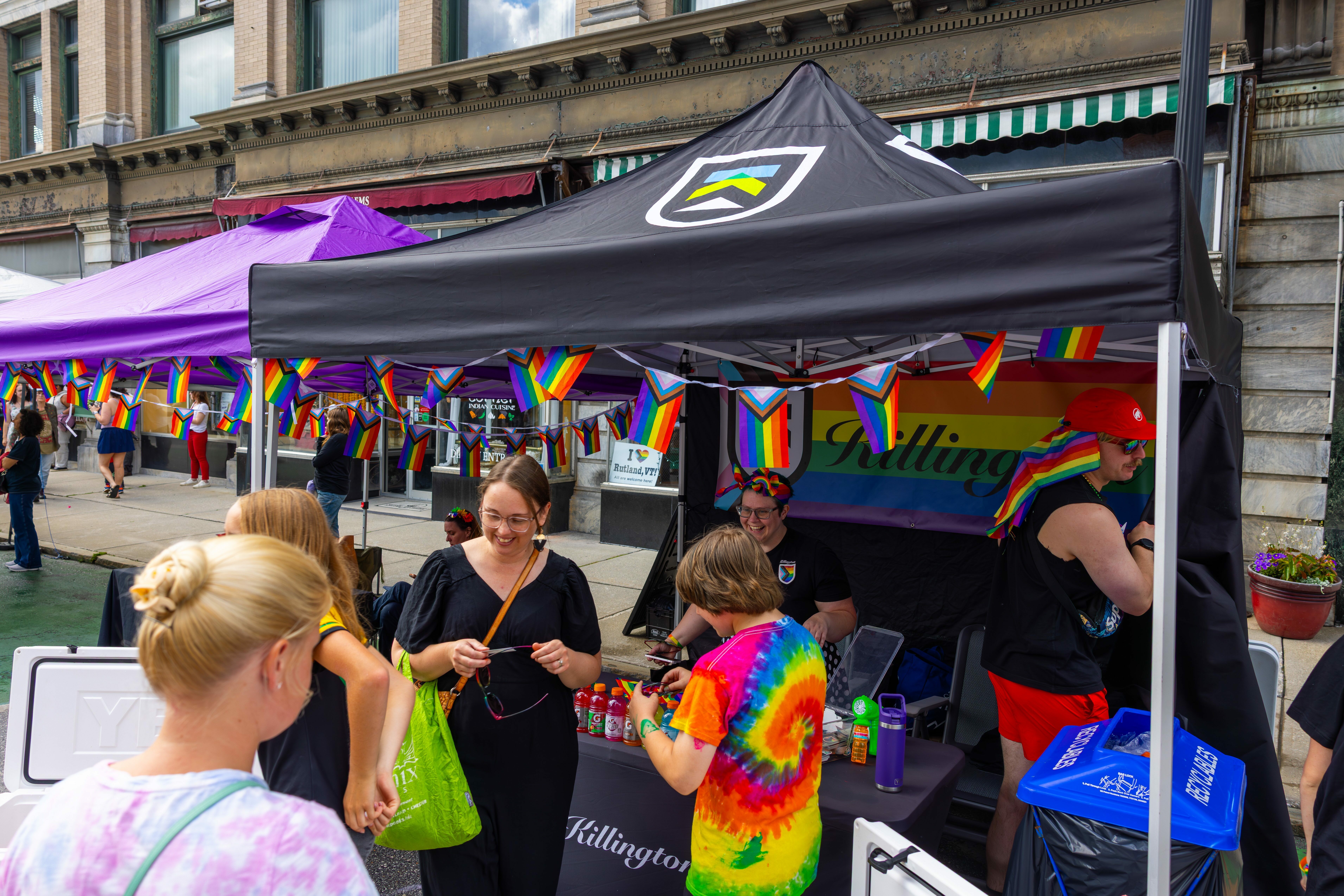 Attendees gather at pride festival booth