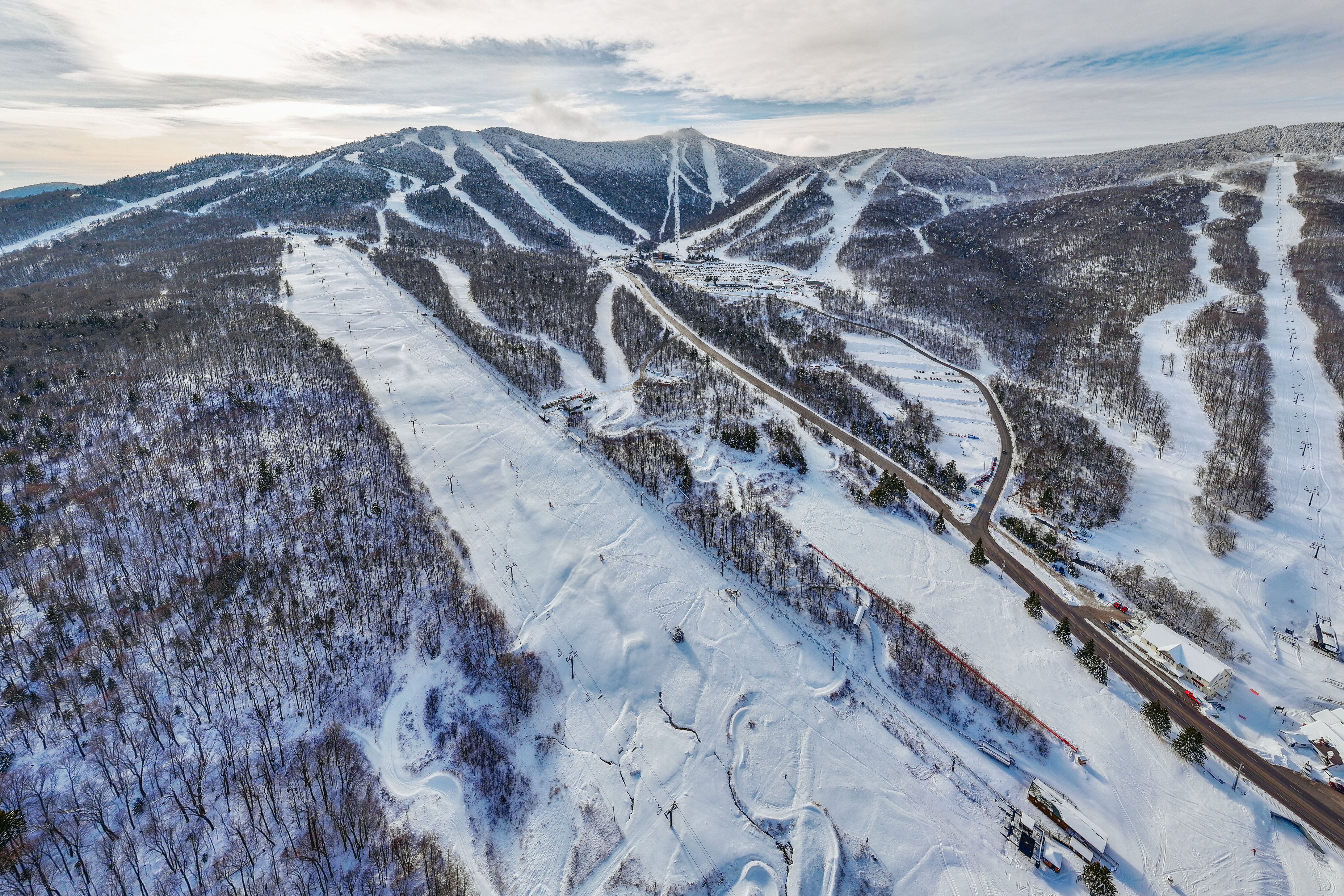 Aerial view of snow-covered ski slopes and a winter landscape.
